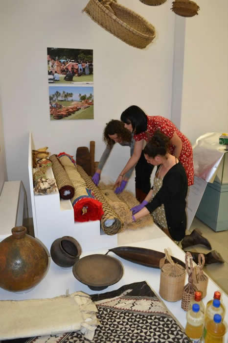 Lucie, Katrina and Karen examining a mat that will be exhibited